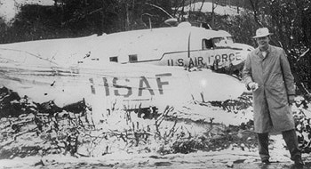 WFEA's Palmer Payne in front of the C-47 wreckage he survived in 1956